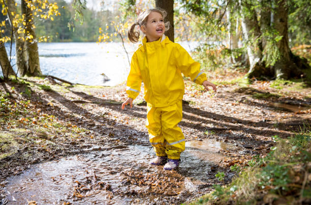 istock Cute little girl jumping in muddy puddle 840614674
