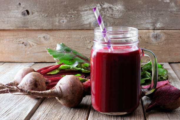 istock Beet juice in a mason jar over rustic wood 840617358