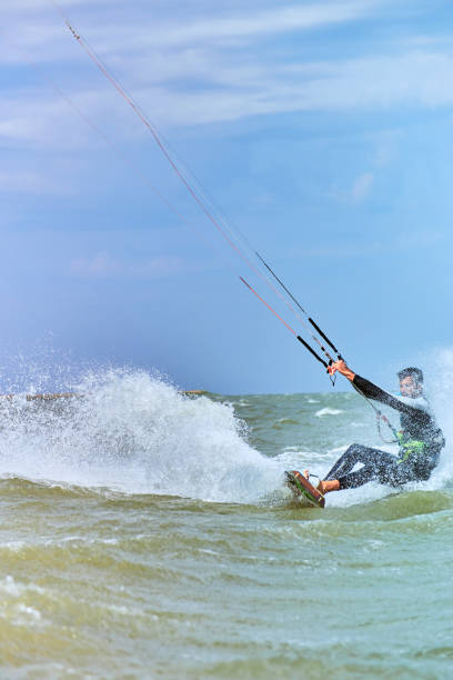 istock Kitesurfing on waves at sea in summer. 840618036