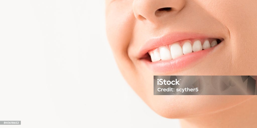 Beautiful smile young woman. White teeth on the master plan. Beautiful smile young woman. White teeth on the master plan. Free space and background to use. Smiling Stock Photo