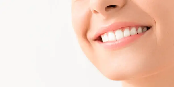 Photo of Beautiful smile young woman. White teeth on the master plan.