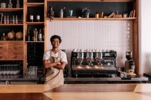 istock Barista in apron looking at camera and smiling 840619338