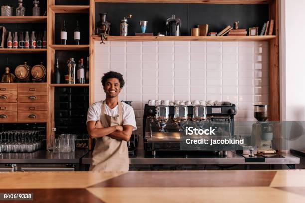 Barista In Apron Looking At Camera And Smiling Stock Photo - Download Image Now - Coffee Shop, Owner, Small Business