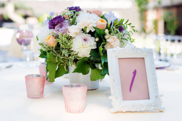 istock Flower table decorations for holidays and wedding dinner. Table set for holiday, event, party or wedding reception in outdoor restaurant. 840620116