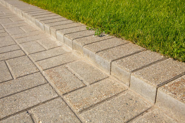 istock road and lawn divided by a concrete curb 840622314