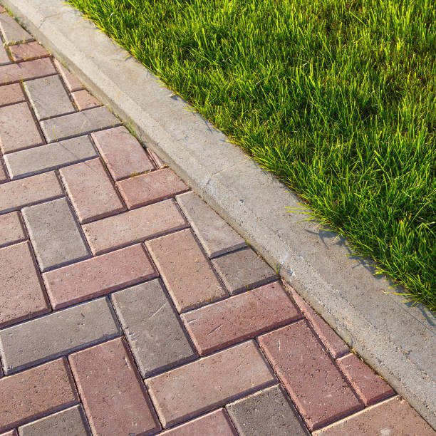 istock road and lawn divided by a concrete curb 840622870