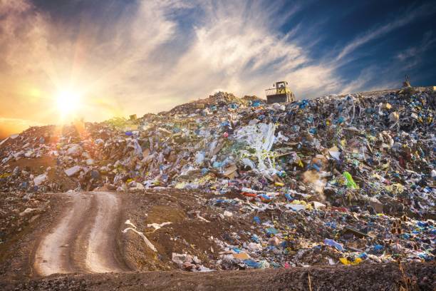 pollution concept. garbage pile in trash dump or landfill at sunset. - garbage dump imagens e fotografias de stock