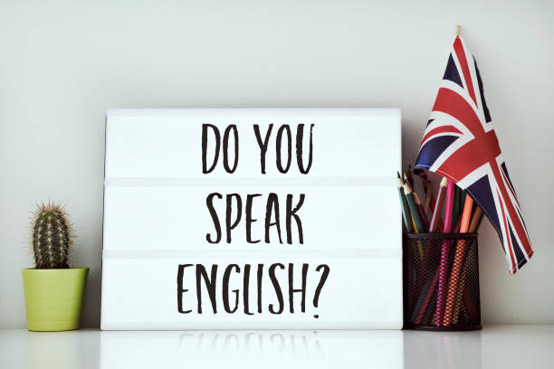question do you speak English? a lightbox with the question do you speak English? written in it, a cactus, a pot of pencils and a flag of the United Kingdom on a white table, against a white background british culture stock pictures, royalty-free photos & images