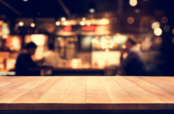 istock Wood table top with blur night cafe background 840627814