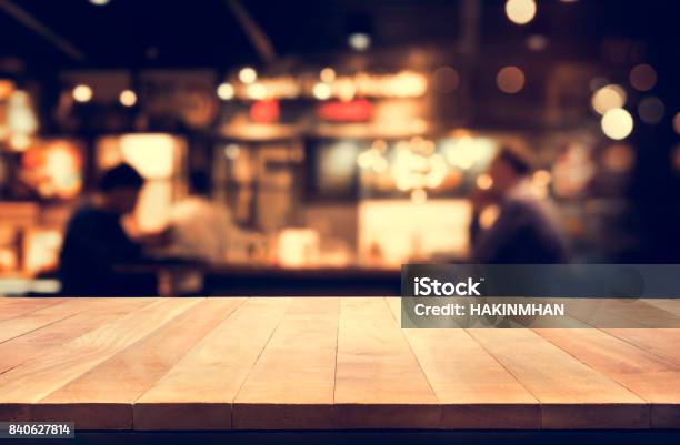 Wood Table Top With Blur Night Cafe Background Stock Photo - Download Image Now - Crowded, Pub, Christmas