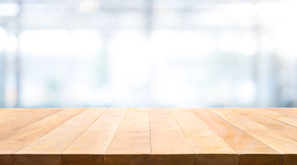 istock Wood table top on glass wall abstract background. 840627938
