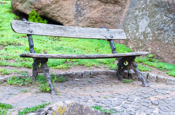 istock Empty old wooden bench in the park. 840630832