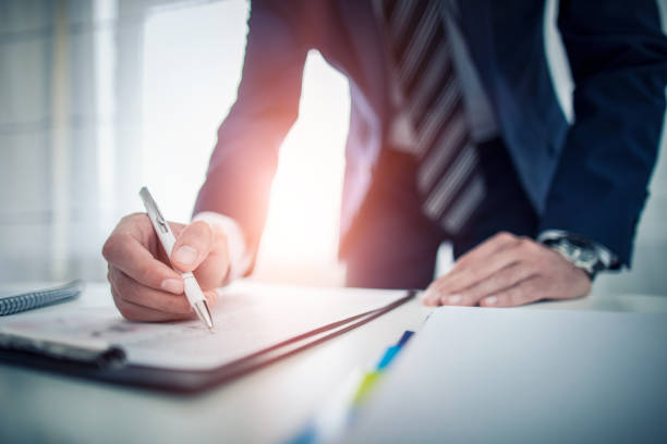 Business man signing contract, making a deal. Business man signing contract document on office desk, making a deal. form document photos stock pictures, royalty-free photos & images