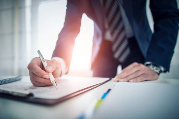 Business man signing contract, making a deal. Business man signing contract document on office desk, making a deal. handwritten signatures stock pictures, royalty-free photos & images