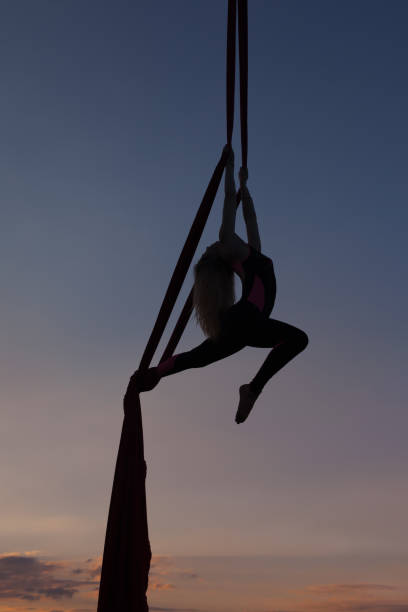 istock Female acrobat in the air on the hammock. 840635360