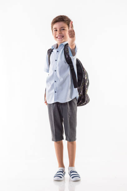 istock Happy little schoolboy standing isolated on white background 840636116
