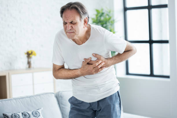 Old man with heart attack stock photo