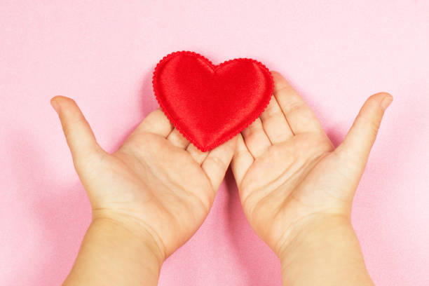 istock Children's hand and heart 840639422