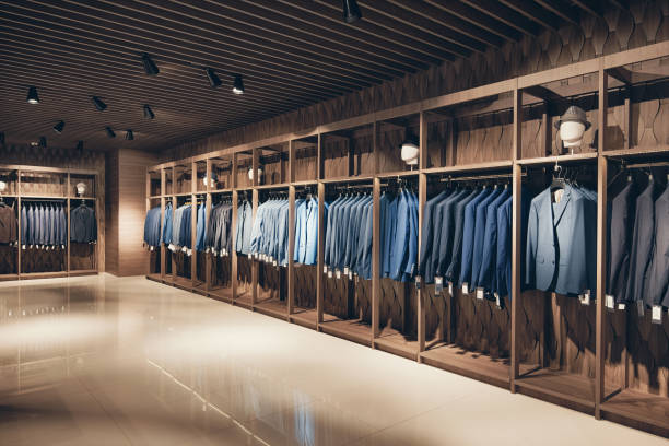 Strict premium  suits Interior of the business suit shop. Strict premium expensive suits hang in a row on hangers in large quantities clothing store stock pictures, royalty-free photos & images