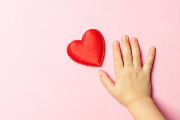 istock Children's hand and heart 840639822