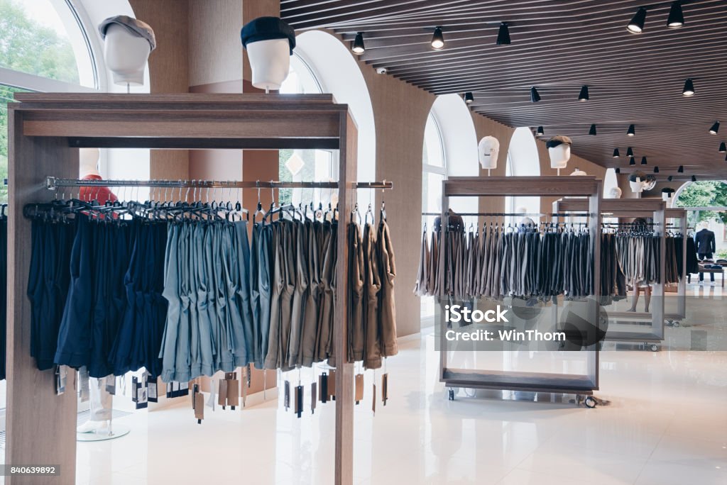 interior of clothing store interior of clothing store. On the hangers of sweaters, shirts, dresses. Clothing Store Stock Photo