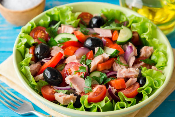 istock Salad with vegetables and tuna on rustic blue wooden table 840640102