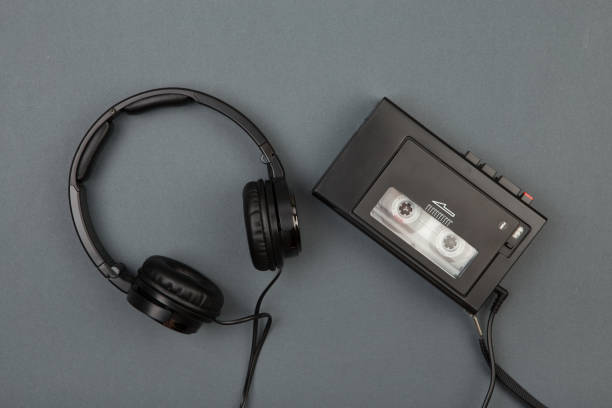 istock Retro cassette player with headphones on grey background 840640362