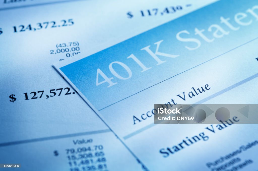 Close Up Of Several 401k Statements Light streams accross a close up of a 401k retirement statement. 401k - Single Word Stock Photo