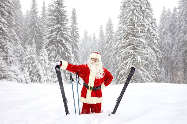 Santa Claus skiing in the mountains on snow in winter in Christm stock photo