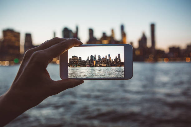 A world-famous view Shot of woman's hands photographing New York City skyline hudson river photos stock pictures, royalty-free photos & images