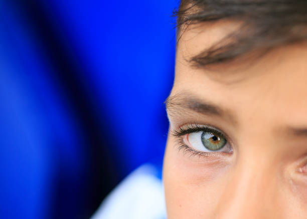Macro of a woman's beautiful green eyes. Extreme shallow depth of field with selective focus on center of eye.