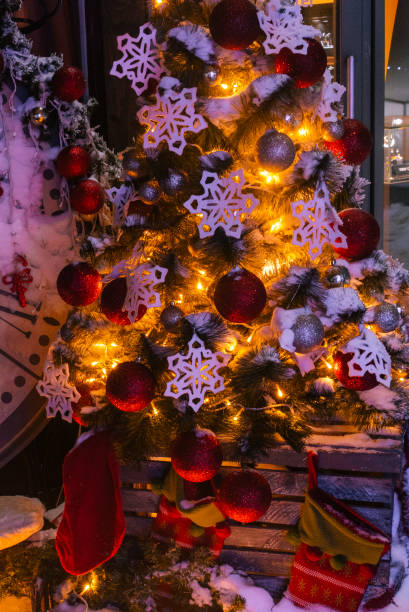 istock Christmas background with illuminated fir tree and fireplace, clock at house 840666298