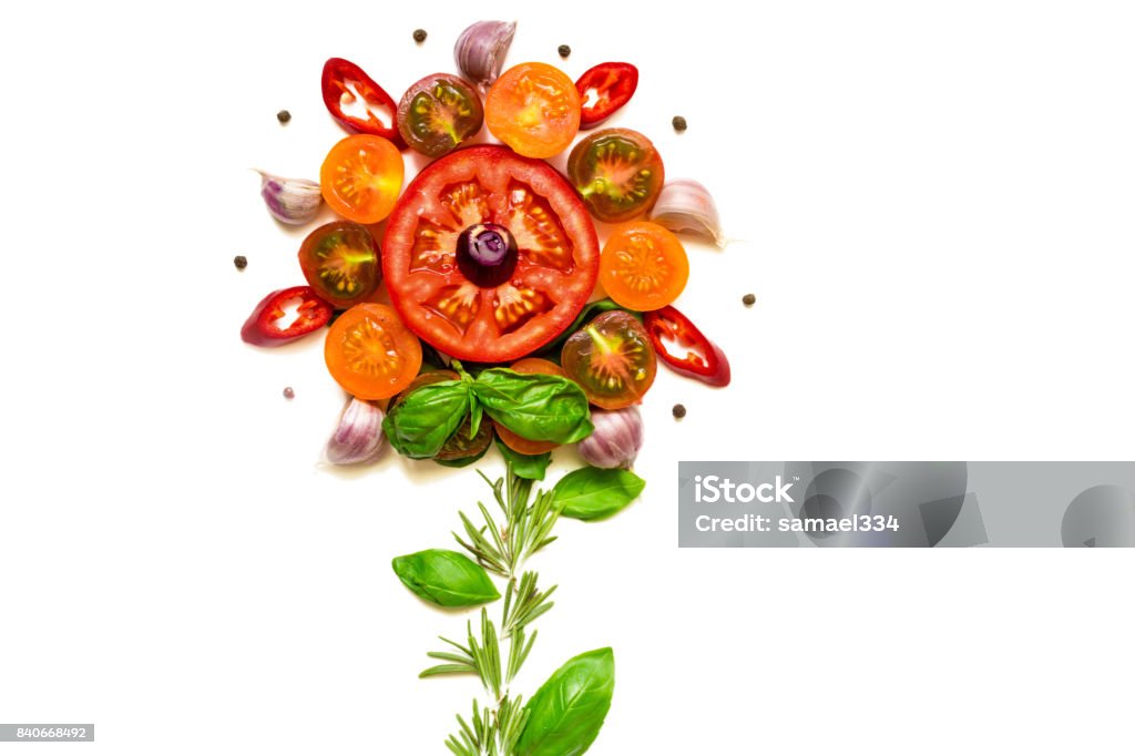 Flower concept made with healthy fresh tomatoes, vegetables, herbs and spices Flower concept made with healthy fresh tomatoes, vegetables, herbs and spices isolated on white background. top view Flower Stock Photo