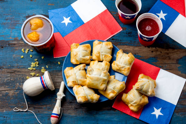 Chilean independence day concept. fiestas patrias. Chilean typical dish and drink on independence day party, 18 september. Mini empanadas, mote con huesillo, wine with toasted flour, chicha and tipical play emboque stock photo