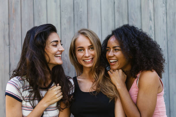 istock Three beautiful young women having fun outdoors 840668652