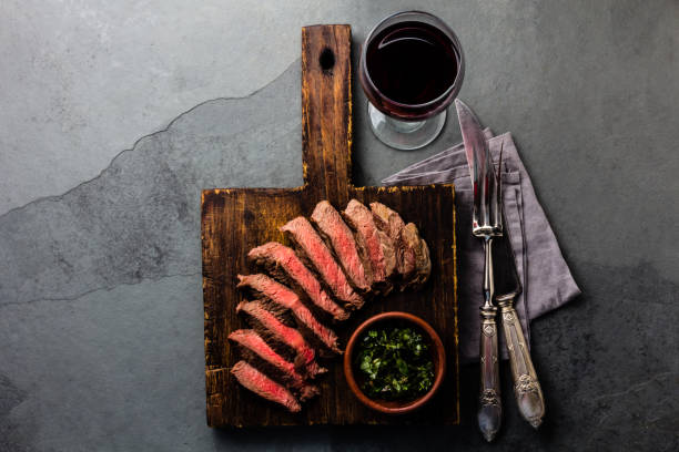 istock Medium rare beef steak with wine on slate background 840668706