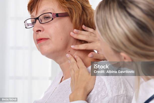 Doctor Dermatologist Examines Birthmark Of Senior Woman Checking Benign Moles Laser Skin Tags Removal Stock Photo - Download Image Now