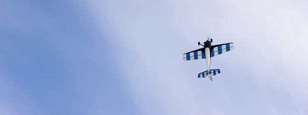 istock Radio controlled toy airplane against blue sky with white clouds 840686188