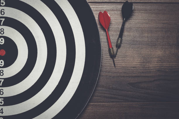 istock target and two darts on wooden background 840696162
