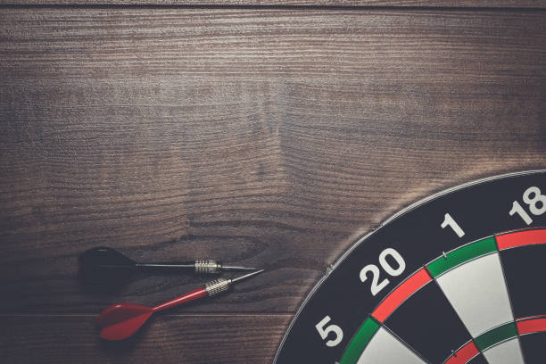 istock target and two darts on wooden table 840696214