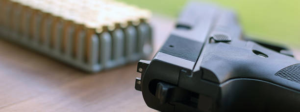 istock Gun with bullets. Handgun box with new ammunition. 840697760