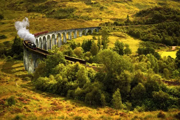 Jacobite steam train on old viaduct in Glenfinnan, Scotland