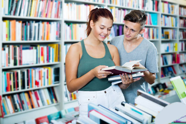 istock Girl and boy in book store 840703600