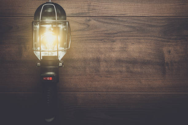 istock hand lamp on wooden background 840705086