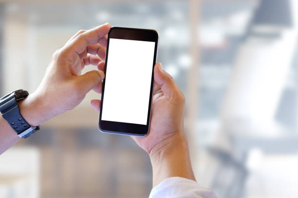 istock Man holding smartphone with blurred office background. For Graphic display montage. 840712098