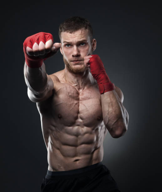 istock Muscular kickbox or muay thai fighter punching. 840718452