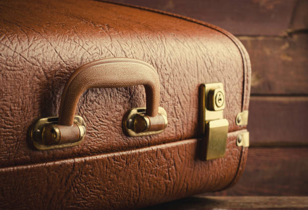 istock Old vintage, retro suitcase on dark background. Front view 840718640