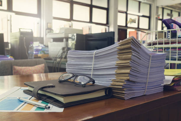 istock Concept of document workload, Pile of unfinished documents on office desk, Stack of business paper, Vintage effect 840719078