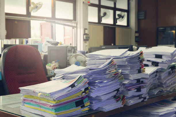 istock Concept of document workload, Pile of unfinished documents on office desk, Stack of business paper, Vintage effect 840719100