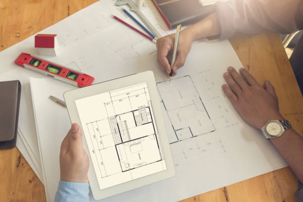 istock Engineer and Architect concept, Engineer Architects office team working and discussing house plan with blueprints and house model, Vintage Effect 840719668